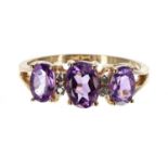 14k yellow gold amethyst and diamond ring, with three oval amethysts and four small diamonds,
