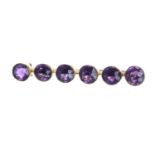 Amethyst gold mounted brooch, rub-over set with six round amethysts, 4.2gm, 44mm wide