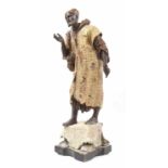 Large Austrian painted spelter figure of an Arabesque street vendor, modelled on a rug and plinth,