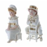 Two Royal Worcester porcelain figures modelled as seated boy and girl, gilded highlights, factory