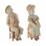 Two Royal Worcester blush ivory porcelain figures, modelled as a seated sleeping boy and seated