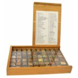 Collection of herb/spice specimens, contained within a display case with slide cover branded Heinz