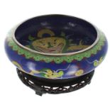 Japanese cloisonne circular shallow bowl upon a hardwood stand, decorated with dragons upon a blue