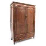 Chinese hardwood cupboard, with two panelled doors enclosing shelved interior, over two short