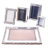 Five silver photograph frames; one decorated with scrolling foliage and stamped 925, marked 'AH',