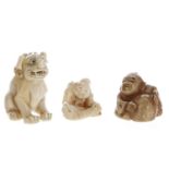 Three antique Japanese ivory netsuke, the buddhistic lion 1.75" high (3)
