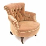 Late Victorian upholstered tub nursing chair, with button-back beige velvet upholstery upon short