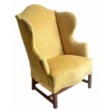 Georgian style mahogany framed wing armchair, with mustard Draylon upholstery and serpentine seat