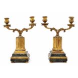 Pair of carved giltwood twin-branch sconce candelabra, modelled upon reeded columns on faux veined