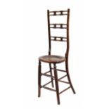 Regency beechwood child's correction chair, with turned high ladder back over an oval caned seat,