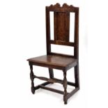 Antique English oak backstool, the wavy cresting rail over a plain panelled splat and solid seat