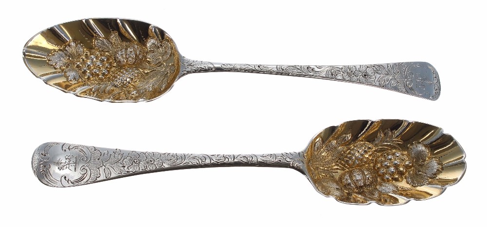 Two similar Georgian silver serving spoons, with gilt embossed bowls and foliate engraved handles,