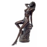 Art Deco style bronze figure of a female nude reclining on a draped pillar, in the manner of