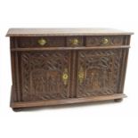 Large antique Continental carved oak sideboard, the rectangular top over three short drawers and