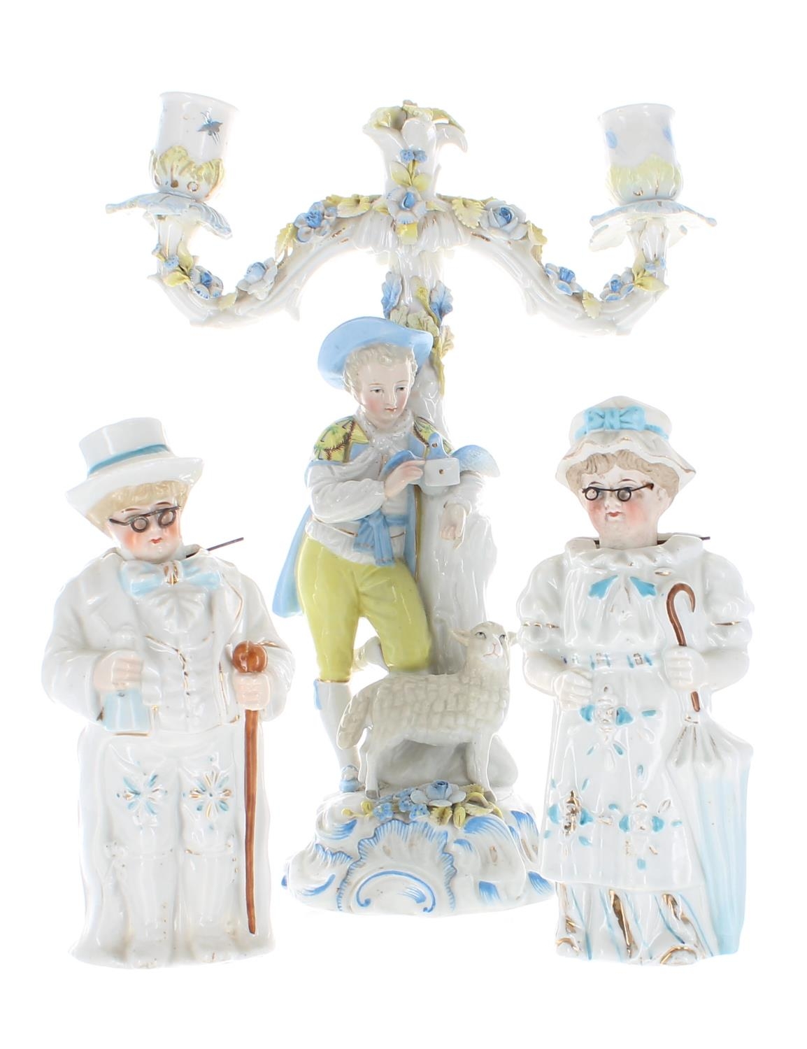 Late 19th century German porcelain figural two branch candelabra, modelled with a shepherd boy