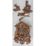 Contemporary carved cuckoo wall clock, 10.75" wide (at fault) with two weights and pendulum