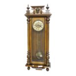 Vienna two-train walnut wall clock, with mask pediment over column case, 41" high (pendulum and