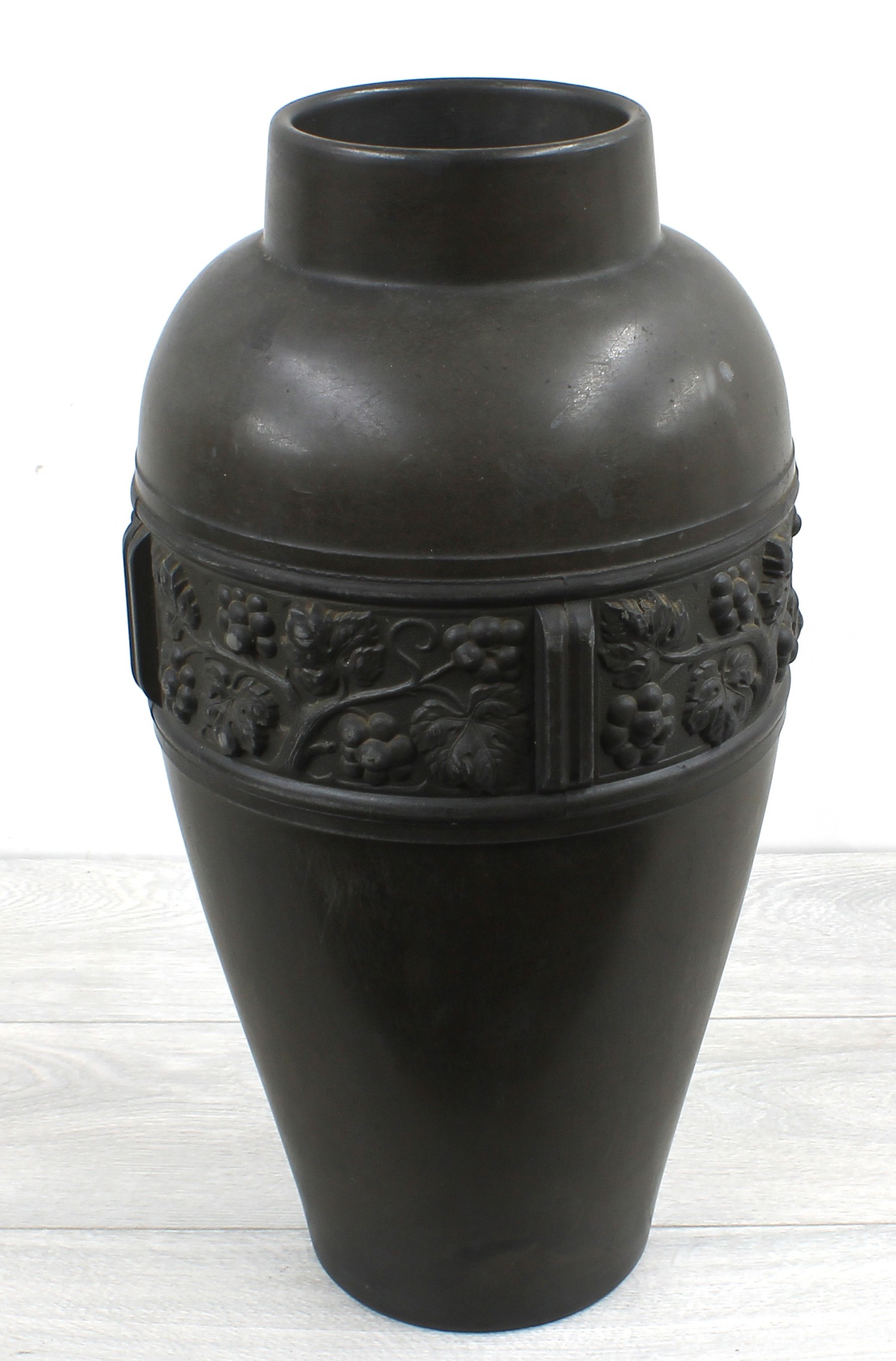 Large pottery bronze effect baluster vase, decorated in relief with a band of fruiting vine, stamp