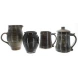 St Ives studio glazed stoneware jug and two tankards, impressed marks, the jug 6.75" high;