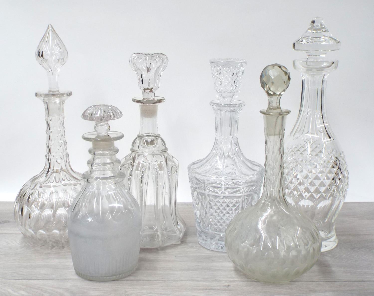 Six assorted 19th century and later glass decanters and stoppers, the tallest decanter 13" high