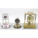 Kundo quartz torsion style brass clock, 9.5" high; together with a Schatz torsion style clock and