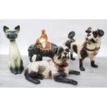 Two similar pottery figures of pug dogs, the standing pug 14.5" high (the front leg on the recumbent