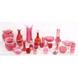 Collection of cranberry glassware including vases, bowls, decanter, jug, assorted drinking glasses