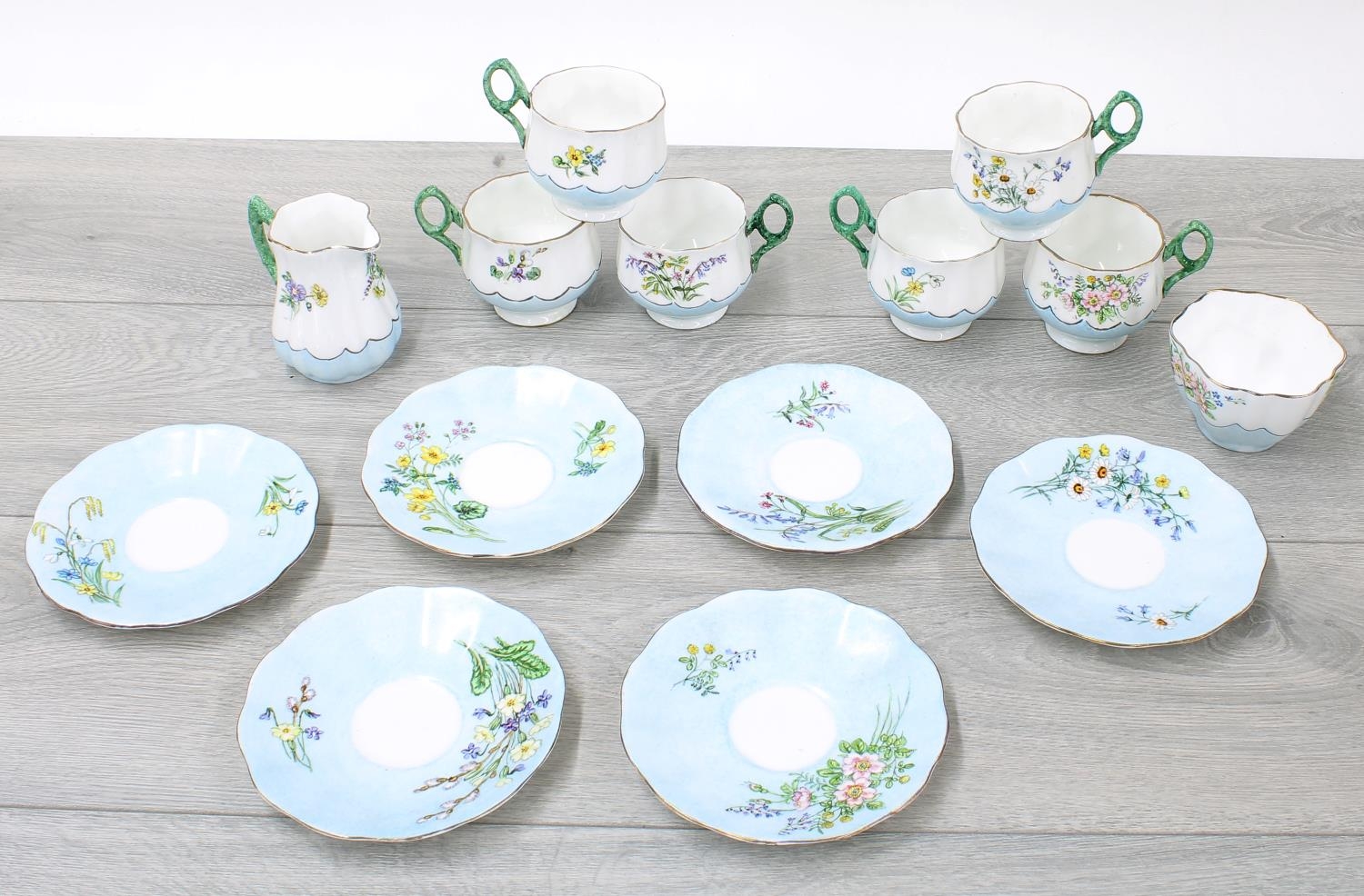 Attractive porcelain fluted tea service for six painted with flowers within pale blue borders,