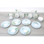 Attractive porcelain fluted tea service for six painted with flowers within pale blue borders,