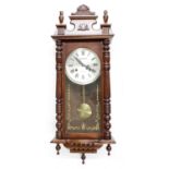 Vienna type 31 day two-train wall clock, the dial signed Lauraln, with shaped pediment and