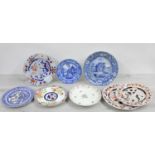 Collection of pottery and porcelain plates including a blue and white 'Palladian Porch' pattern