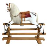 Good Lines Brothers Ltd rocking horse with leather saddle and reins stamped LB Ltd SP2, 52" wide,