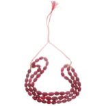 String of earth mined carved red oval beads on a red and gold adjustable cord. 2415.50ct