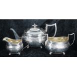 George III three piece boat shaped silver tea set, comprising teapot 6" high, twin-handled sucrier