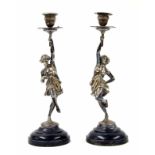 Pair of cast figural silver plated candlesticks, modelled as classical figures holding aloft a