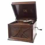 His Masters Voice (HMV) wind-up table top gramophone, within oak case with fretwork grille below,