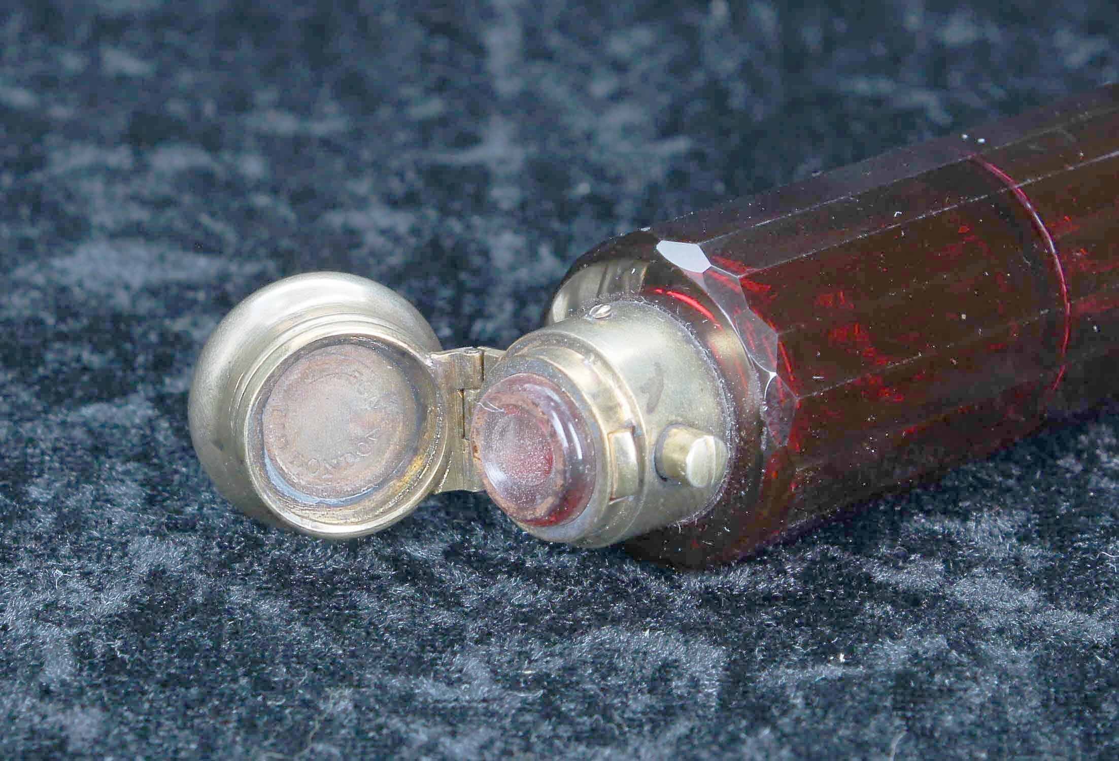 Victorian cranberry glass double-ended scent bottle, the facet cut bottle with gilded white metal - Image 3 of 3