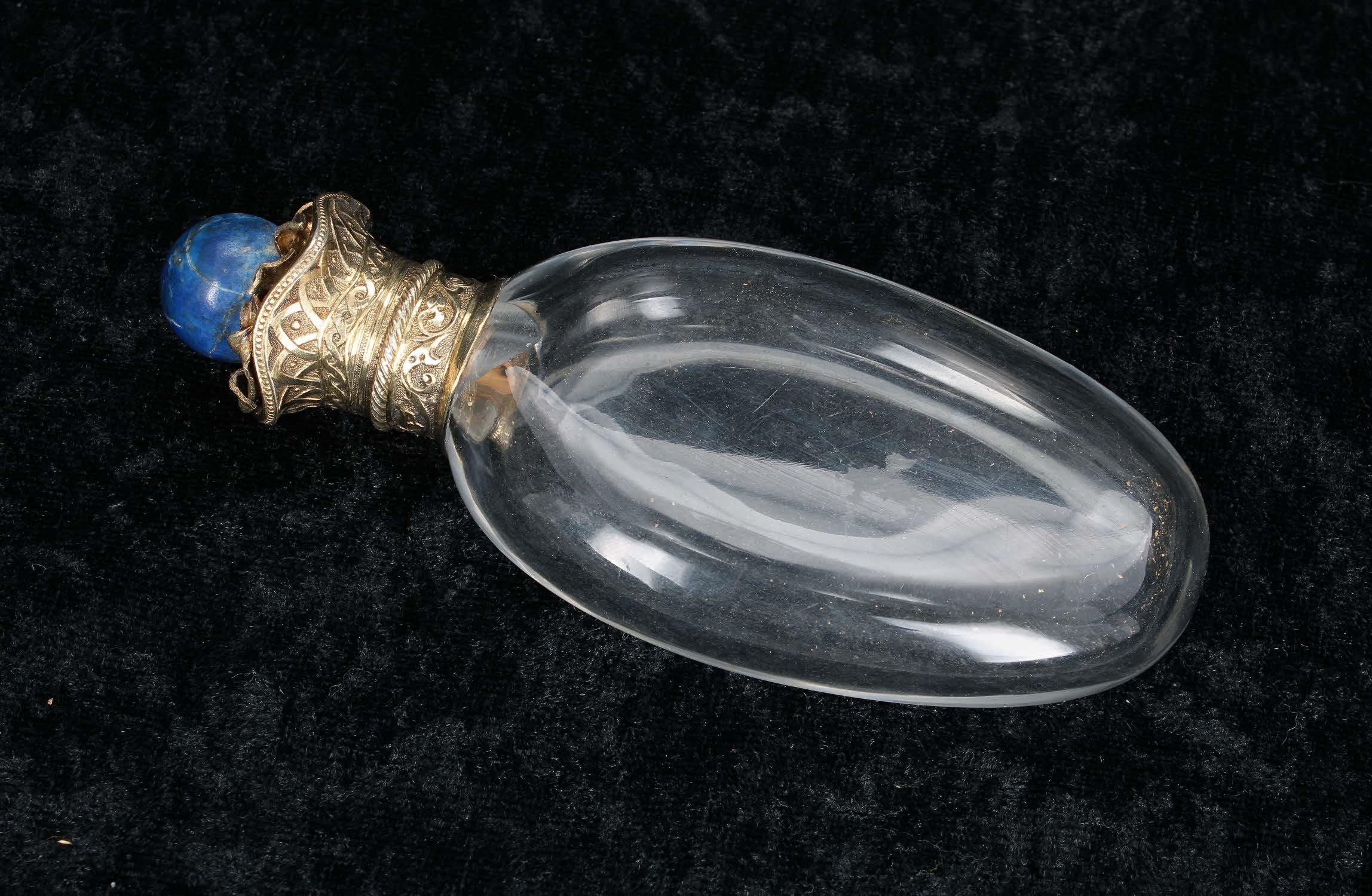 19th century gilt metal mount clear glass oval scent bottle, the gilt hinged cover elaborately