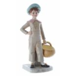 Royal Worcester - a James Hadley design porcelain figure of a boy with basket, wearing a pale blue