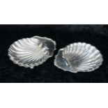 Pair of Josiah Williams & Co. silver scallop shell dishes, raised on three ball feet, London 1922,