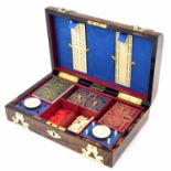 Good Victorian walnut games box, the domed cover with brass strapwork, enclosing fitted interior