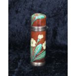 Late 19th century enamelled cylinder perfume bottle, decorated with wild flower sprays on brown