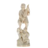 Japanese carved ivory okimono depicting a fisherman with paddle and a young boy by his feet,