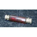 Victorian cranberry glass double-ended scent bottle, the facet cut bottle with gilded white metal