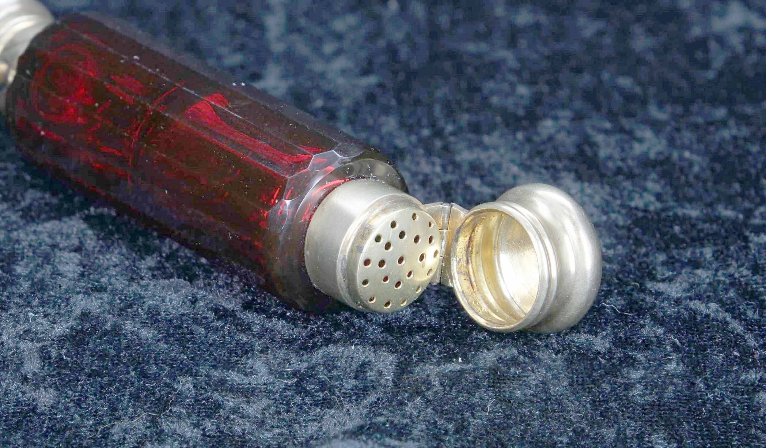 Victorian cranberry glass double-ended scent bottle, the facet cut bottle with gilded white metal - Image 2 of 3