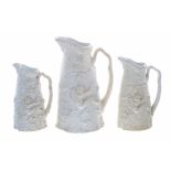 Trio of graduated T J & J Mayer relief moulded biscuit porcelain jugs, with boy and birds nest