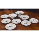 A. Lanternier Limoges porcelain dessert service, enamelled with birds upon gilded branches,