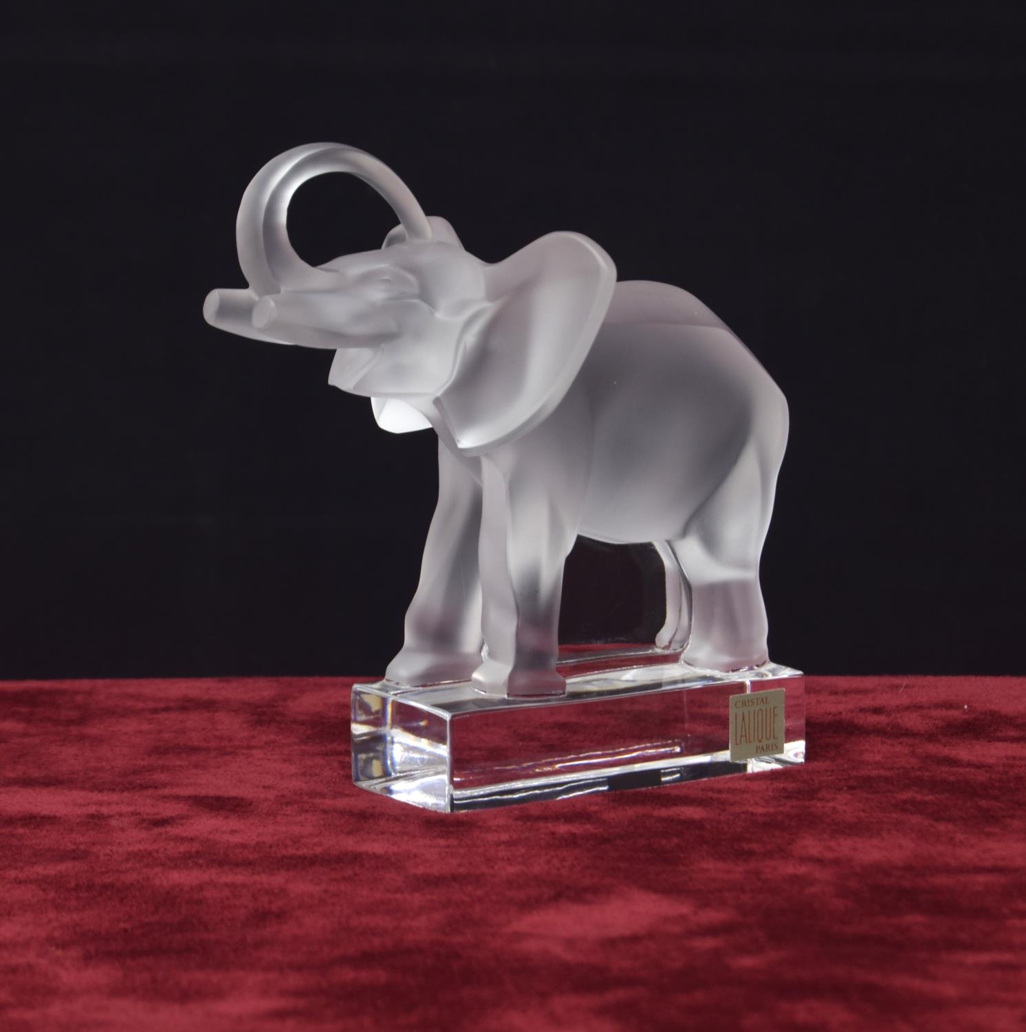 Lalique moulded clear and frosted glass model of an elephant, with a raised trunk upon a plinth