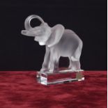 Lalique moulded clear and frosted glass model of an elephant, with a raised trunk upon a plinth