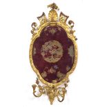 19th century oval giltwood and gesso Girandole mirror, the bevelled plate within a foliate moulded